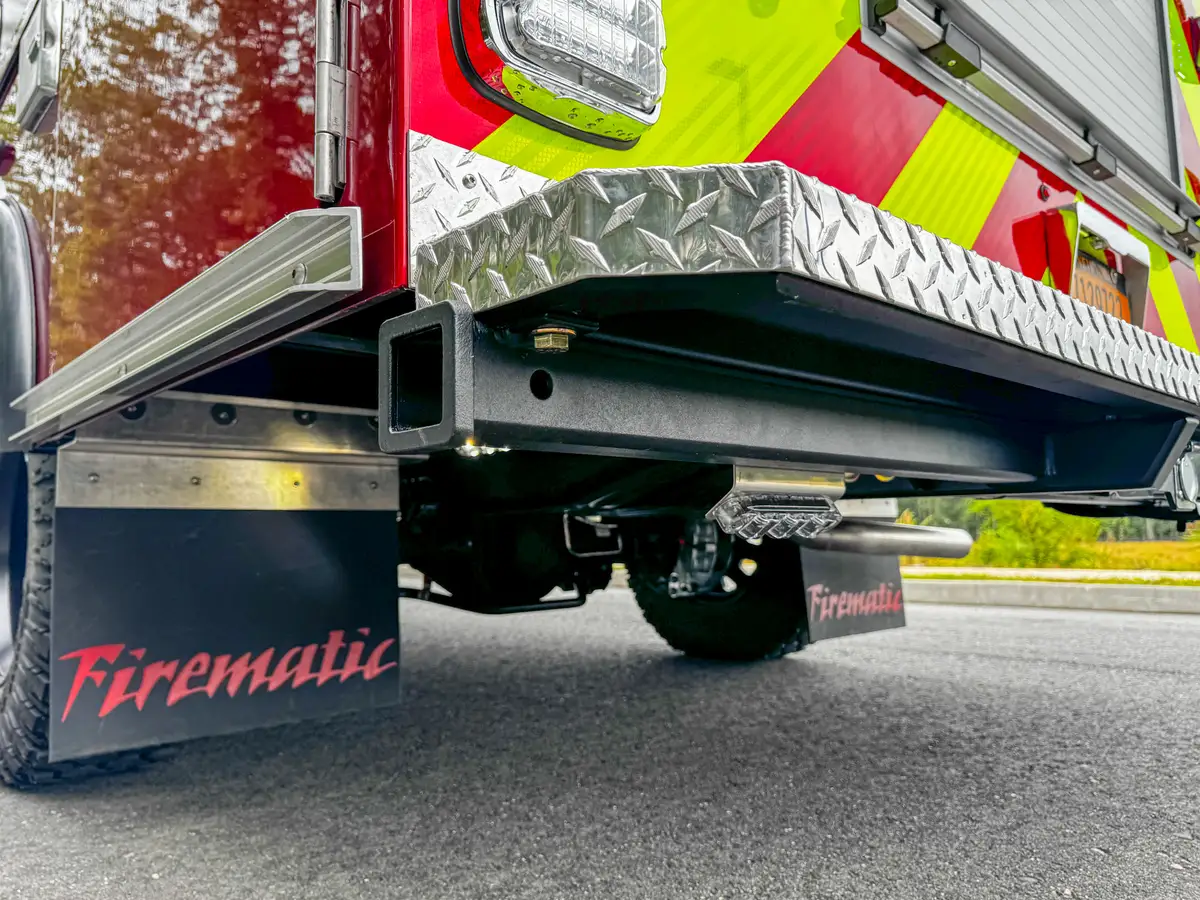 Rear-quarter underside view with frame rails and mudflap visible.